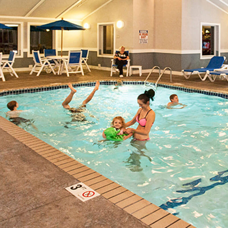 a mother having fun with kids in the poor of Park Point Marina Inn's Indoor Family Center