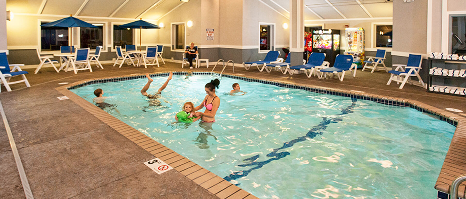 a mother having fun with kids in the poor of Park Point Marina Inn's Indoor Family Center